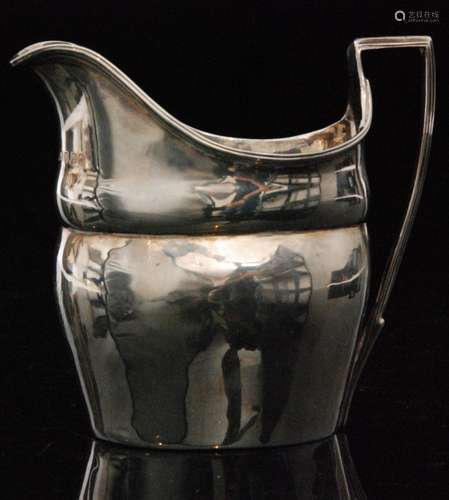 A George III hallmarked silver helmet shaped cream jug with reeded rim, London 1800, makers mark rubbed.