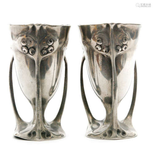 A pair of Art Nouveau pewter vases of goblet form, cast in low relief with stylised rose heads, each with three strut supports, stamped Kayserzinn 4489, height 12cm, S/D. (2)