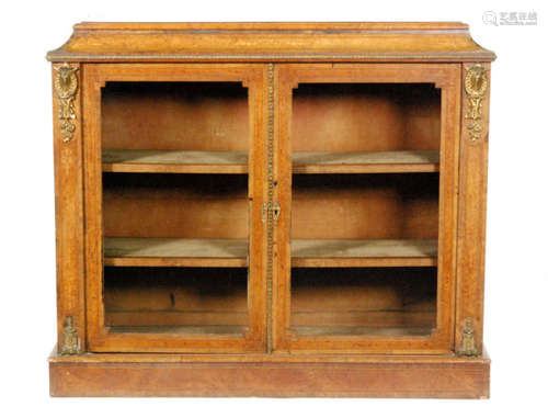 A 19th Century figured walnut credenza with gilt metal mounts, enclosed by a pair of line inlaid and banded glazed doors below a concave caddy shaped top, width 118cm.