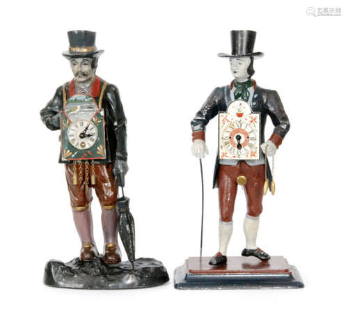 A 20th Century spelter novelty clock figure of a man wearing a top hat and holding a cane in Georgian dress and a similar figure holding an umbrella, the painted dial decorated with a bird, height 41cm (2)