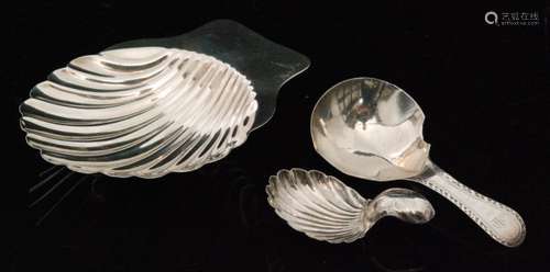 A George III hallmarked silver caddy spoon with fluted bowl and bright cut handle, London 1790 Hester Bateman, another with fluted shell bowl and short domed handle, Birmingham 1814, John Lawrence & Co (2)