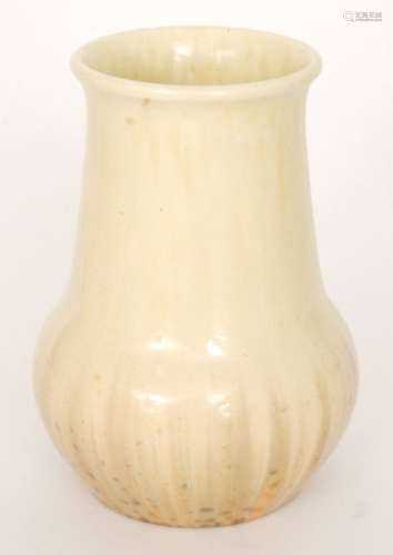 A Ruskin Pottery crystalline glaze vase decorated in a streaked yellow over orange with green spotting, impressed mark and dated 1930, height 20.5cm.