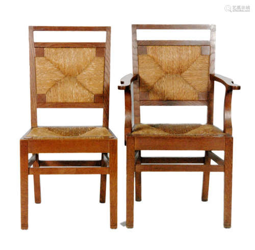 A set of six early 20th Century Cotswold School Arts and Crafts dining chairs, comprising four side chairs and two carvers, each with a woven grass drop-in seat pad above a stretcher frame (6)