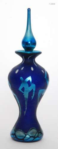 An Okra studio glass Firedance scent bottle by Richard Golding and Sarah Cowan of hourglass form below a spire stopper decorated with iridescent figures over the deep satin blue ground, engraved signature, height 20cm.