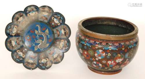 A late 19th Century Japanese cloisonne jardiniere decorated with roundels of flowers on a black ground, width 24cm, also a similar wavy edge shaped dish decorated with a stylised dragon chasing a flaming pearl on a blue ground, width 25cm. (2)