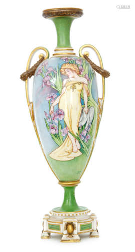 An early 20th Century Royal Worcester Art Nouveau shape 1686 pedestal vase, the body decorated with a hand painted maiden dressed in yellow with gilt jewellery surrounded by purple iris against a tonal blue and purple ground, monogrammed RJD, the neck and foot in green with gilt laurel wreaths to the handles, puce mark with indistinct date code, height 47.5cm, S/D