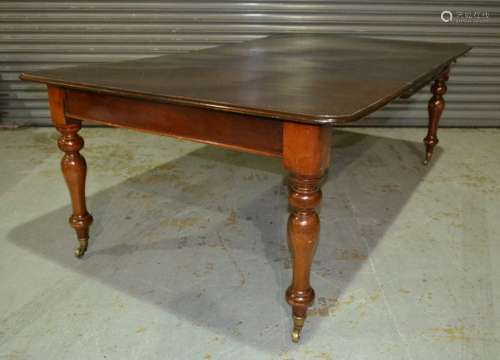 A late Victorian mahogany extending dining table, the moulded edge top over a plain frieze on turned baluster legs and castors, length 210cm extended.