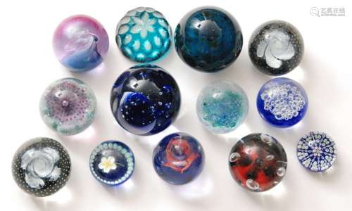 A large collection of assorted 20th Century glass paperweights to include Wedgwood, Czech and Caithness examples. (qty)