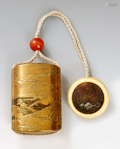 A mid 19th Century five case inro decorated in togidashi, gold tkamakie and kirigane with a village beside a lake nestling in hills, signed Kajikawa with red bronze ding form kakihan to base, simulated agate bead ojime and kagamibuta netsuke with ivory cup and metal disc engraved with a toad in a pond, diameter 4.5cm, S/D.   BR 077/28