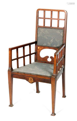 An Arts and Crafts mahogany open armchair, the frame with line inlaid and floral inlay, with lattice style back and arm rests above a shaped front apron and square tapered legs, S/D.