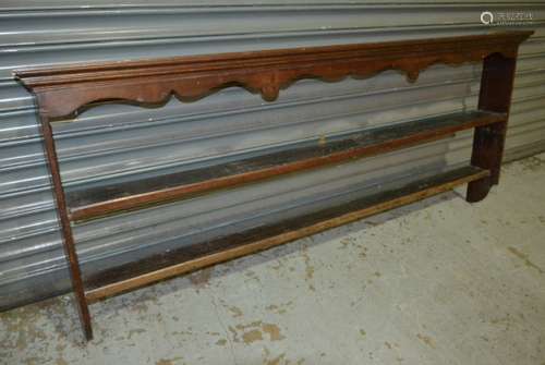 An oak two tier plate rack, with cornice canopy, bears brass maker's label for 'F.Thomas, Cabinetmaker, Halesowen', height 74cm and width 172cm, S/D.