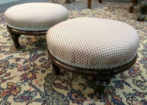 A pair of Victorian mahogany framed foot stools of circular form, each raised to four turned and tapered squat legs, seat height 22cm and diameter 33cm. (2)