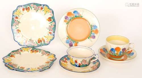 A 1930s Clarice Cliff Newport Pottery trio decorated in the Chloris pattern, Bizarre backstamp and printed pattern name, together with two matching side plates and a Crocus pattern trio (qty)