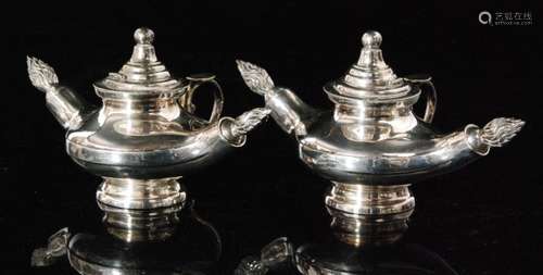 A pair of silver plated table lighters each in the style of an Aladdins lamp with central wick (2)