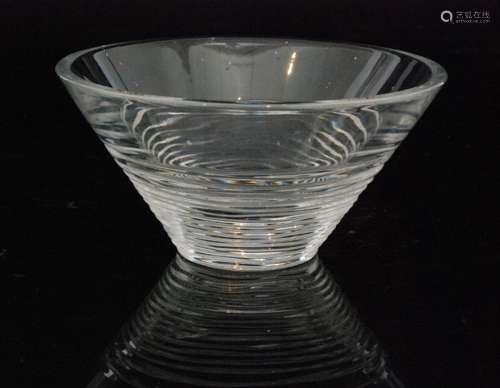 A contemporary Stuart Crystal glass Strata bowl designed by Jasper Conran of conical form decorated with wavy horizontal cutting, acid marked, diameter 15cm.