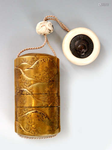 An early 19th Century five case inro, the fundame gold and cut black ground with rolling hills and young pines, length 9cm, with an ivory ojime of a boy and a Daruma toy touched in colour, the ivory kagamibuta netsuke with a silver plate stylised sparrow, diameter 4.2cm, S/D.   BR 077/12