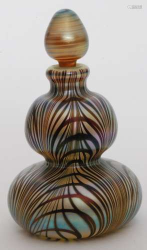 A later 20th Century Okra studio glass scent bottle of double gourd form below a tear form stopper, with pulled loop decoration over the pale green ground all in an iridescent finish, dated 1983, engraved signature, height 11cm.