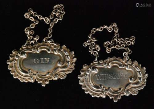 A pair of William IV hallmarked silver decanter labels for Gin and Whiskey, each with leaf and scroll embossed border decoration,  Henry Wilkinson and Co (2)