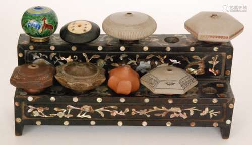 A Chinese green glazed opium bowl decorated with stylised horses, a signed ivory and ebony example, six other terracotta opium bowls and a mother of pearl inlaid hardwood stand (8)