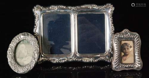 A modern hallmarked silver double easel photograph frame with C scroll and floral border decoration, Sheffield 1996 together with two smaller examples (3)