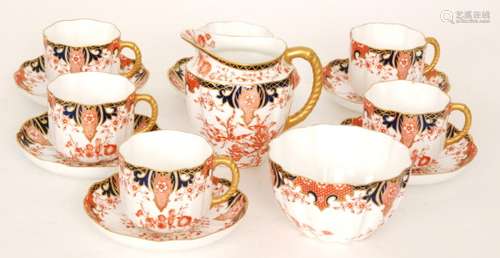 A set of six early 20th Century Royal Crown Derby Imari 2412 pattern breakfast cups and saucers together with a matching sugar bowl and milk jug, all with green printed marks and date codes circa 1905 (qty)