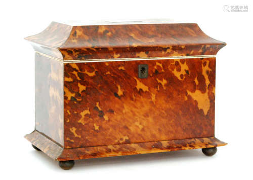 A 19th Century Regency tortoiseshell tea caddy of sargophagal form fitted with two divisions and covers, width 20cm