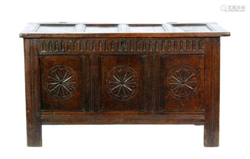 An 18th Century carved oak coffer with triple panelled front below a lunette frieze on stiles, width 126cm