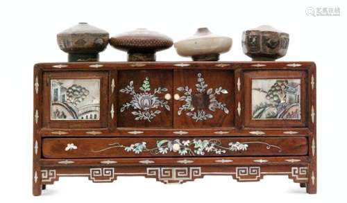 A Chinese hardwood table opium bowl cabinet with mother of pearl inlay decorated with flowers and landscapes to the front over a drawer, together with four opium bowls one in a white hardstone and a signed example, width 27cm