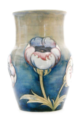 A 1930s Moorcroft vase decorated in the Big Poppy pattern with tubelined tonal pink and blue flowers against a green to blue salt glaze ground, impressed signature mark, signed in green, height 24cm