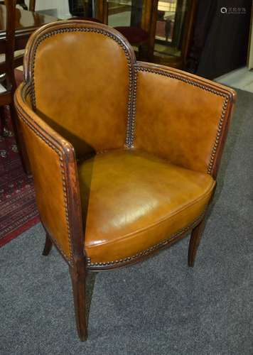 A 1930s oak framed tub shaped easy chair of cloud design upholstered in buttoned tan leather on splayed legs