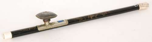 A Chinese opium pipe with black laquered stem etched with a pagoda and characters, enamelled silver saddle with pottery bowl decorated with two lions and bone mouth piece, length 57cm