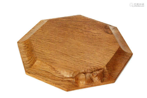 A Robert 'Mouseman' Thompson oak octagonal teapot stand, with concave borders and a carved 'mouse' signature, diameter 18.5cm