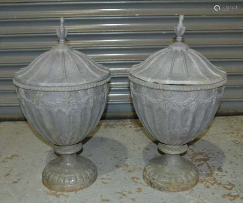 A small pair of Adam style lead urns and covers each with a finial mount, height 60cm (2)