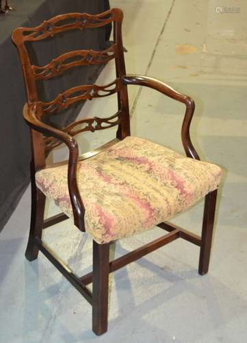 A  mahogany elbow chair with pierced ladder back and an overstuffed seat, with H-form stretcher frame, some later repairs, S/D.