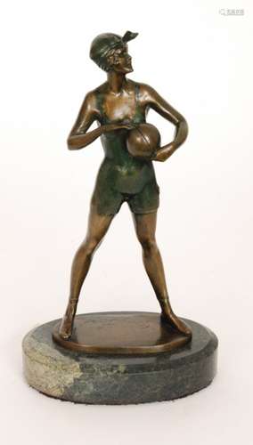 A reproduction Art Deco style bronze figure after Bruno Zach modelled as a female bather standing and holding a ball, raised to an oval marble base, bears signature, height 35cm.