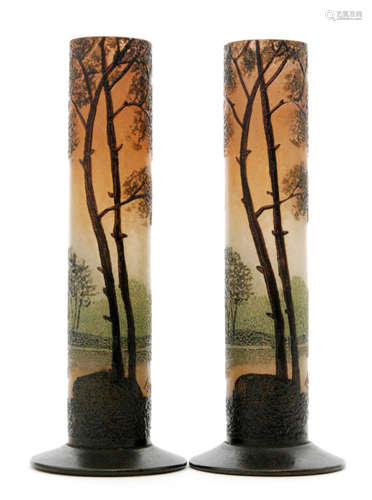 A pair of early 20th Century Legras glass posy vases of footed sleeve form, enamel decorated with trees amongst a natural landscape in an autumnal palette, enamel signature, height 13.5cm. (2)