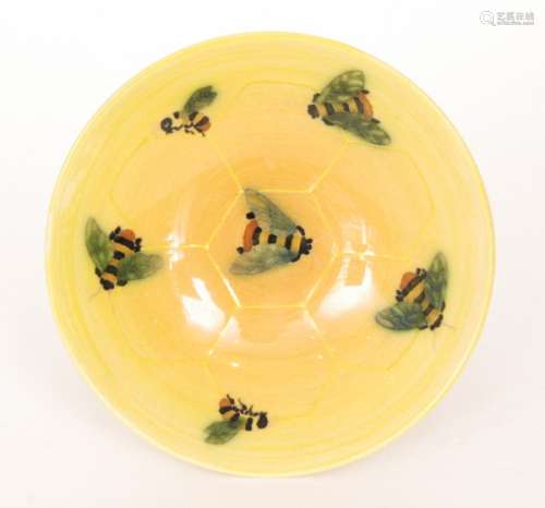 A Dennis China Works tazza decorated with bumblebees on a tonal yellow ground, printed and painted marks, diameter 16cm
