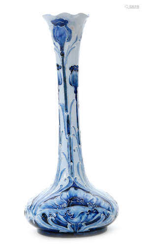 An early 20th Century William Moorcroft for James Macintyre & Co Florian Ware vase of compressed globe and shaft form decorated in the blue on blue Poppy pattern, printed mark and signed in green, height 25cm, restored