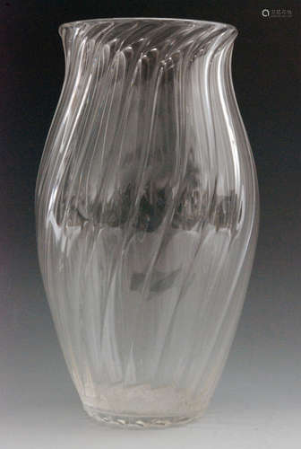 An early 20th Century Stevens & Williams clear crystal glass vase designed by Gordon Russell of swollen sleeve form with wrythen decoration, unmarked, height 24cm.