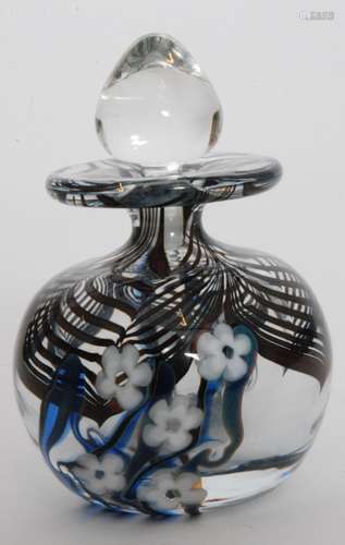 A later 20th Century Okra studio glass scent bottle of globular form with a slender waisted neck and wide flat rim decorated with a deep red pulled loop pattern to the shoulder above white stylised flower heads amongst random blue trailing all below tear form stopper, dated 1983, engraved signature, height 10cm.