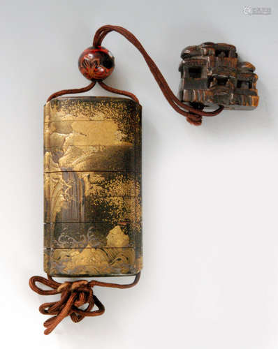 An early 19th Century six case inro finely decorated with torrents and waterfall to a mountainous forest landscape in gold hiramakie and takamakie on a nashiji ground, length 9cm, with a red and black marbled bead cut with flowers and inlaid with mother of pearl studs the wooden netsuke modelled as a three story teahouse circa 1800, height 4cm.   BR 077/18.