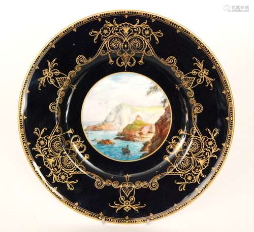 A late 1920s Royal Worcester cabinet plate decorated with a hand painted roundel depicting Lantern Hill, Ilfracombe by J. Walter, the border edge in blue with a gilt overlay pattern, puce mark with date code for 1929, diameter 26.5cm