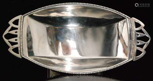 An Art Deco hallmarked silver twin handled boat shaped pedestal bon bon dish of plain form with egg and dart borders, length 22cm, Birmingham 1945, Ernest W Haywood.