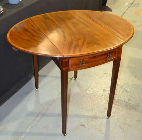 A 19th Century mahogany Pembroke table of oval form, with crossbanded borders, above a single frieze drawer and square tapered legs, width 90cm.