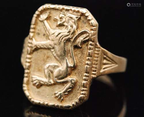 A 9ct hallmarked signet ring, rectangular head with a rampant lion to feathered detailed shoulders, ring size N, Birmingham 1984, Bernard Instone.