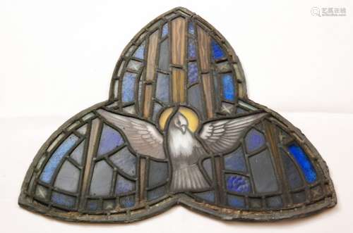 A stained glass panel of trefoil form with a central dove peace surrounded by rectangular sections in blue and yellow, unmarked, length 50cm.