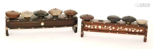 A collection of nine terracotta opium bowls various examples decorated with landscapes, bamboo and fauna bearing character signatures to the underside and two mother of pearl inlaid table stands (11)