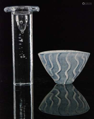 A later 20th Century Kosta Boda glass Tonga bowl by Moinca Backstrom of conical form with hand enamelled wave pattern in pale blue and white, enamel signature, height 9cm, together with a clear crystal Cool candlestick designed by Kjell Engman of cylindrical form with a wide annular rim with random internal air bubble decoration, original label, height 21cm. (2)