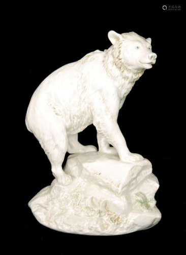 An early 20th Century Alexander von Wahl blanc de chine model of a bear on a rocky base with green and brown tinting, impressed marks, height 24cm