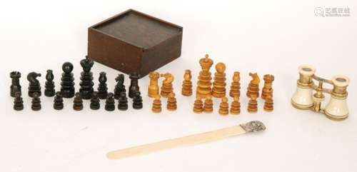 A late 19th Century turned boxwood and ebonised chess set together with a pair of opera glasses and a silver mounted page turner (3)